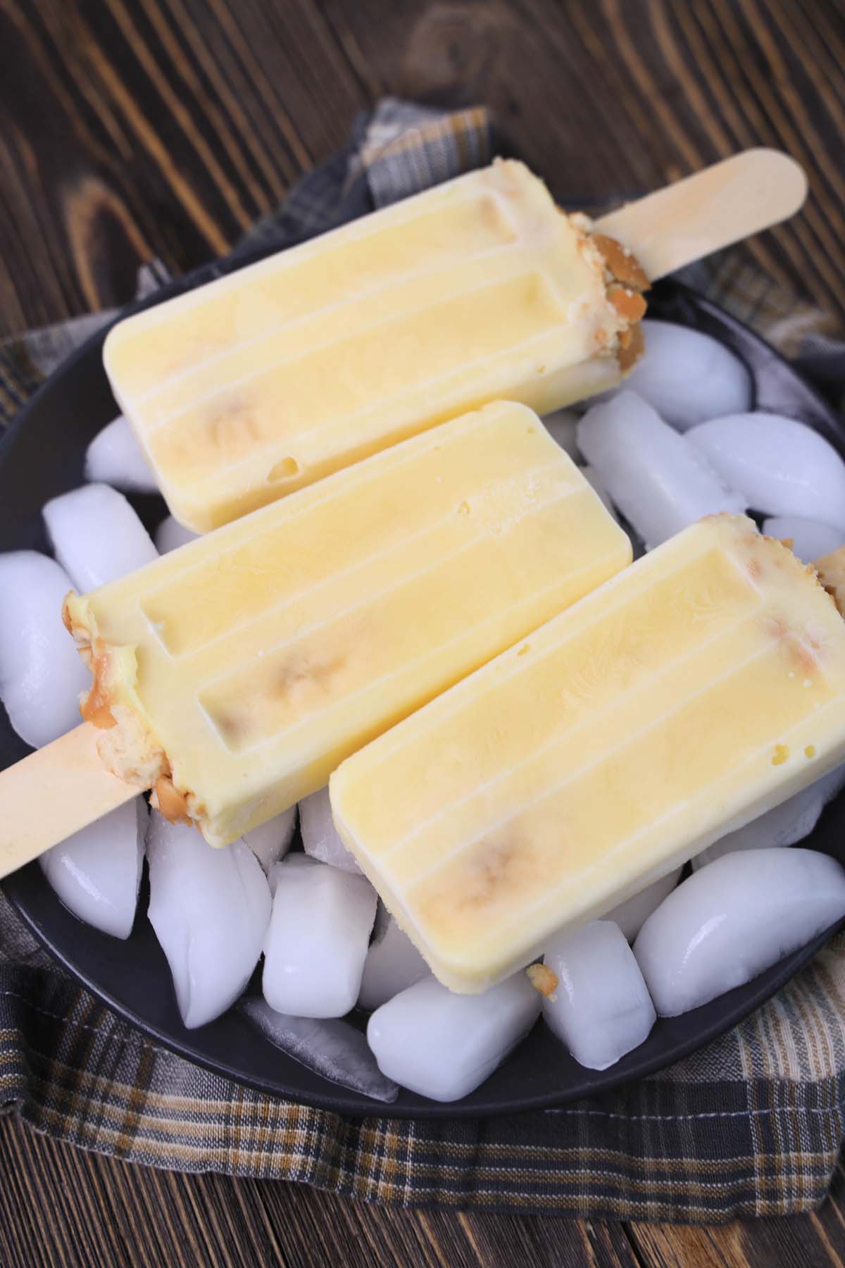 banana popsicles on a plate.