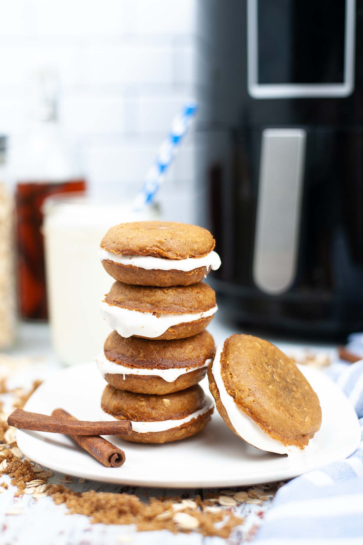 oatmeal creme pies stacked on a white plate.