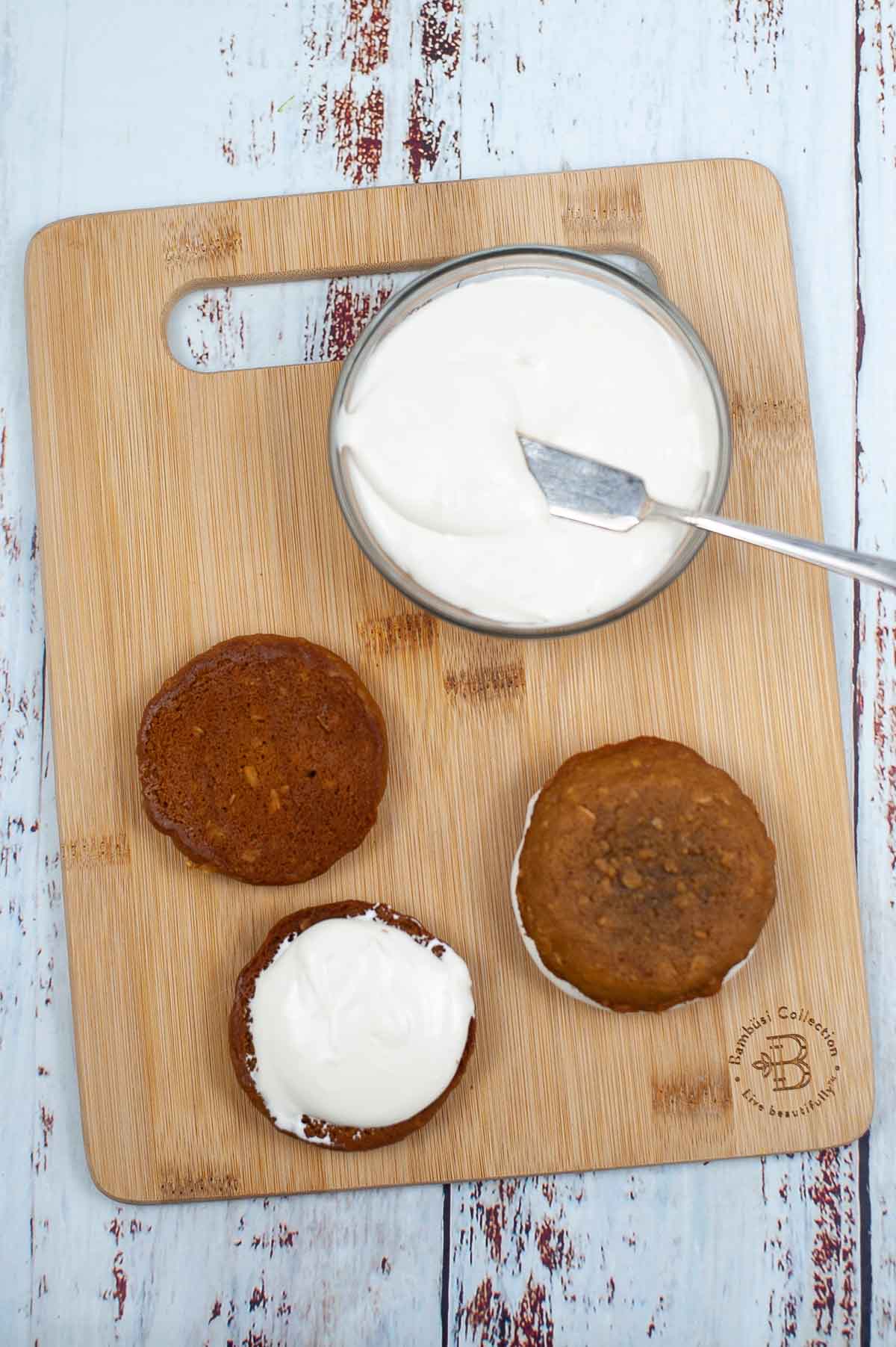 assembling oatmeal creme pies on a cutting board.