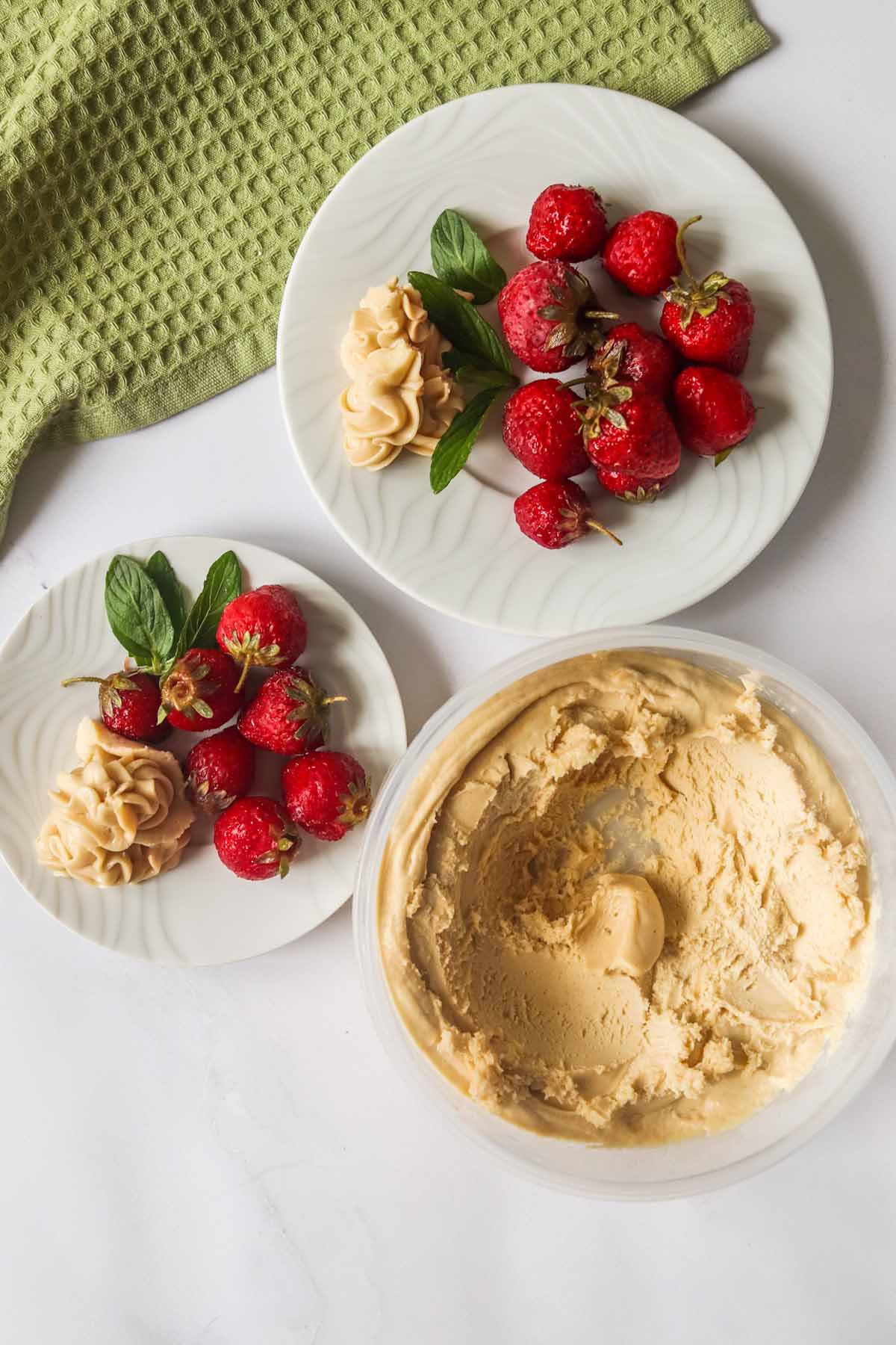 top view of two plates of strawberries with peanut butter dip.