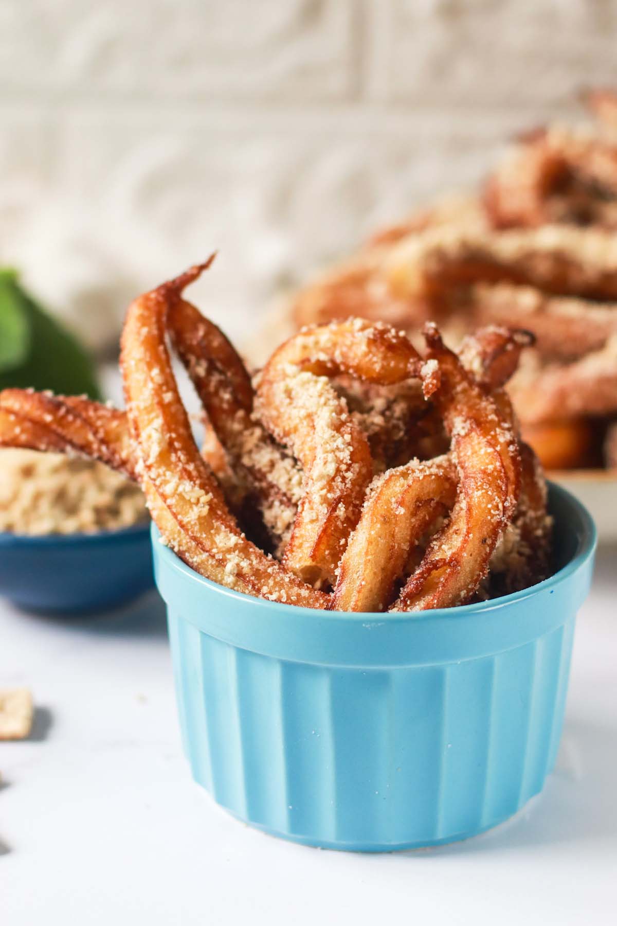 churros stacked in a small bowl.